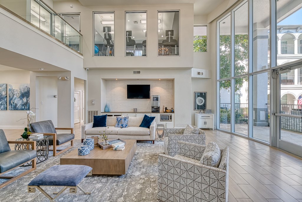 a living room with couches and chairs and a tv