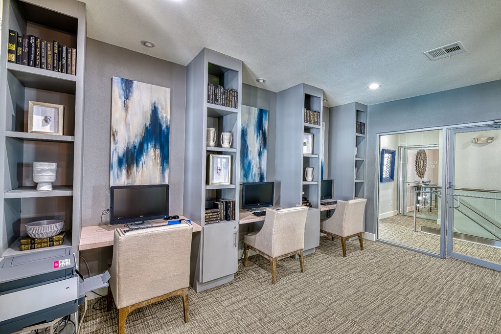 a room with two desks and chairs and a television