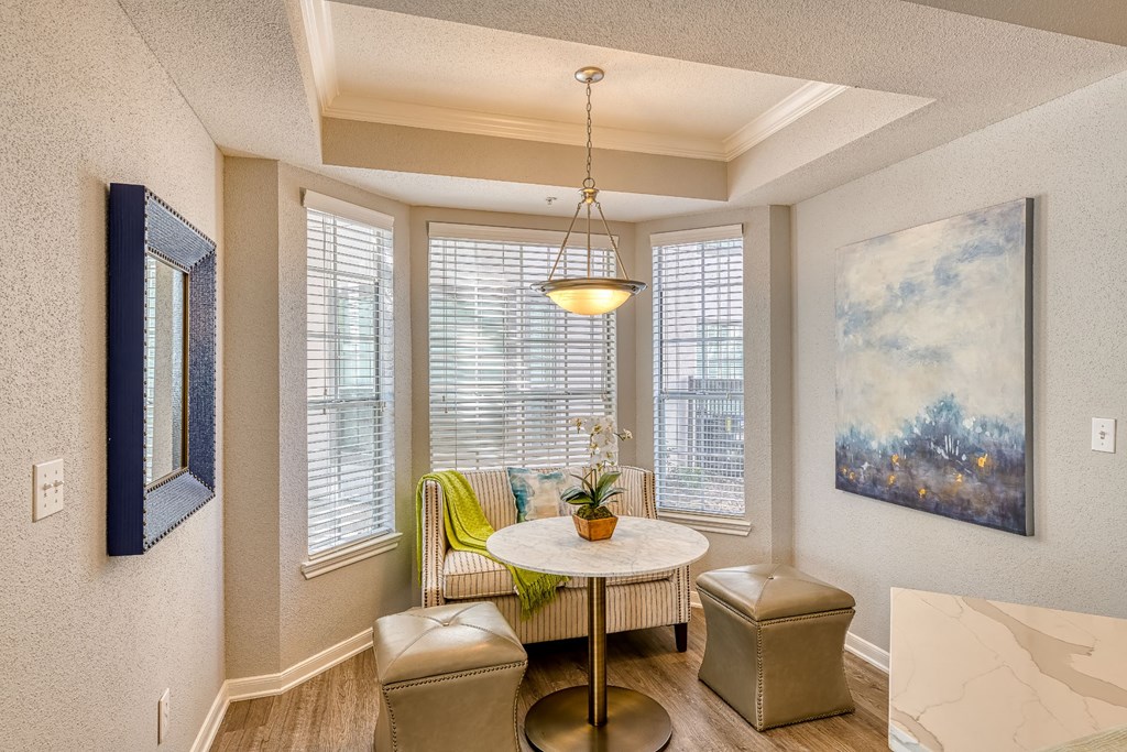 a dining room with a table and chairs and a window