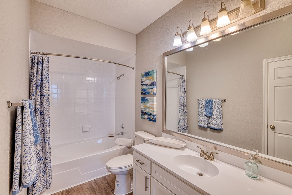 a bathroom with a sink toilet and a tub