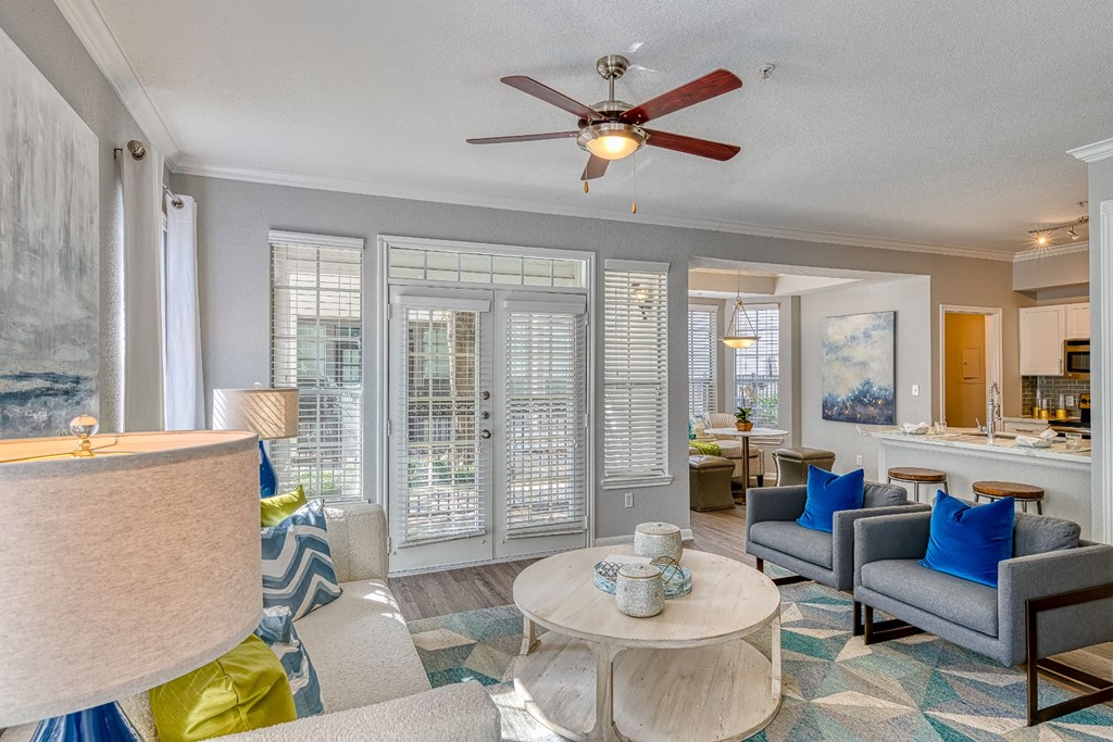 a living room with furniture and a ceiling fan