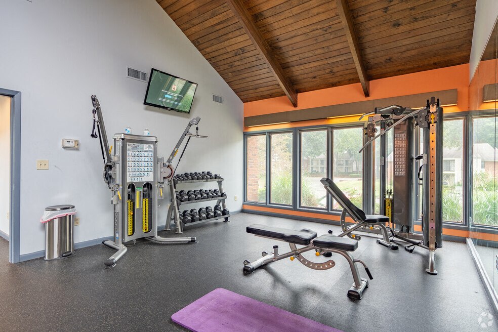 the gym has plenty of equipment and a large window