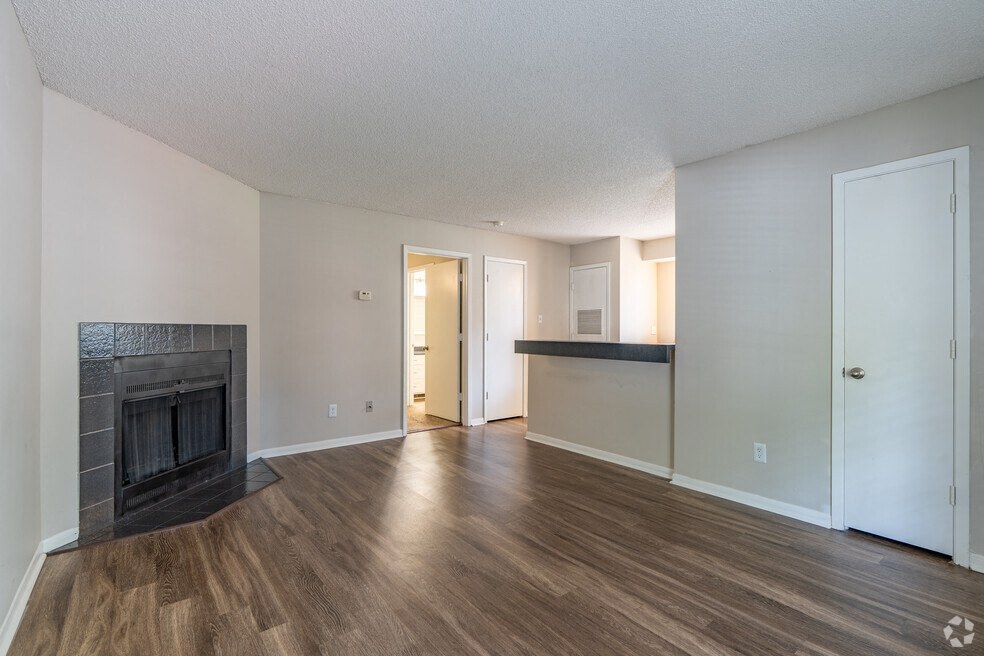 a living room with a fireplace and wooden floors