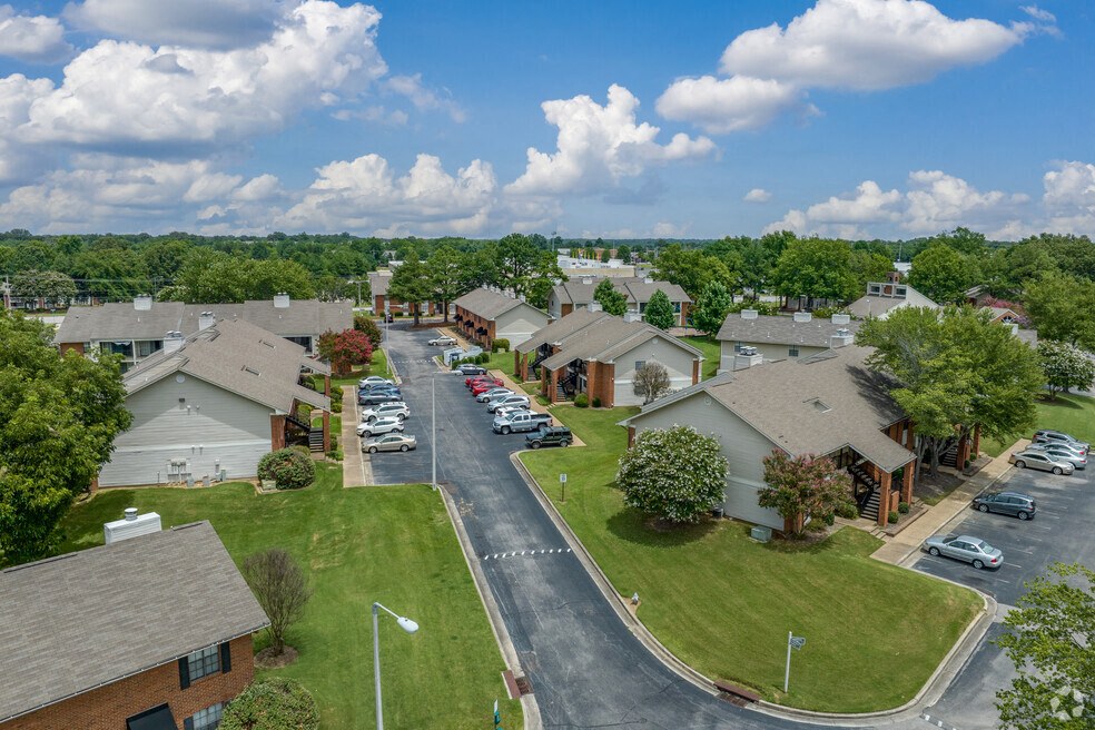 an aerial view of a neighborhood of houses with cars parked