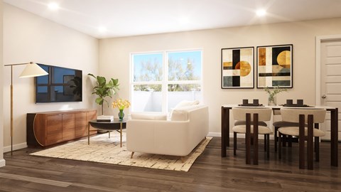 A living room with a white couch, a wooden cabinet, and a television.