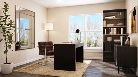 A room with a black desk and a chair with a potted plant beside it.