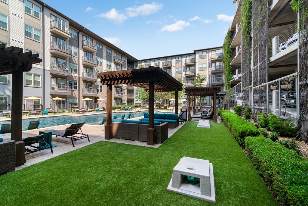 A well-maintained outdoor area with a pool and lounge chairs.