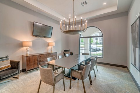 A modern dining room with a large table and chairs.
