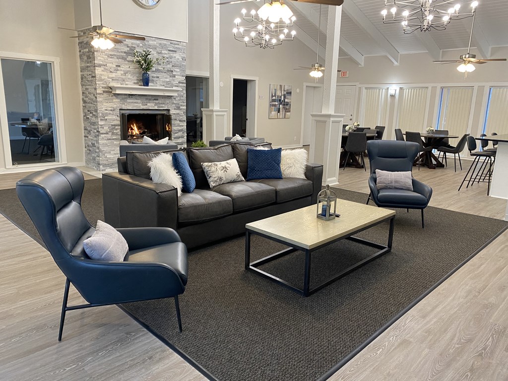 a living room with couches and chairs and a fireplace