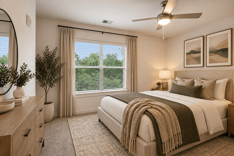 A bedroom with a large bed and a ceiling fan.