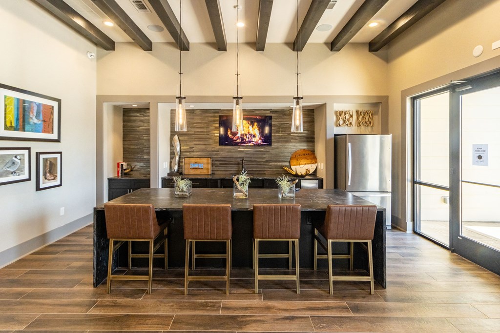 a kitchen with a large center island with a wooden countertop