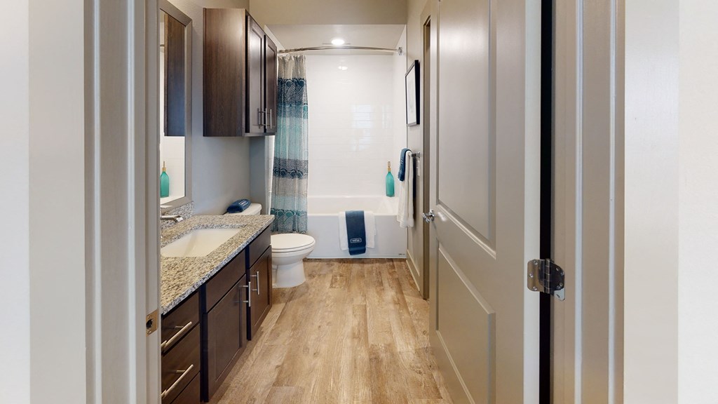 a bathroom with a toilet sink and bathtub in a 555 waverly unit