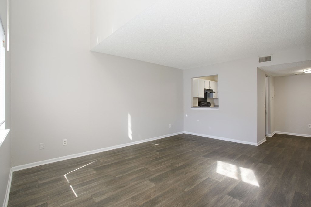 a bedroom with hardwood floors and white walls