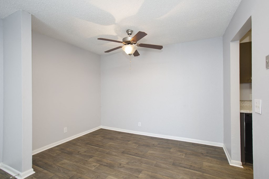 a bedroom with a ceiling fan and hardwood floors