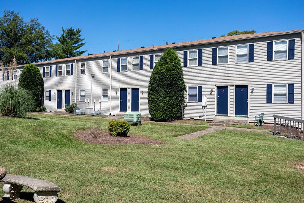 a building with blue doors and white siding