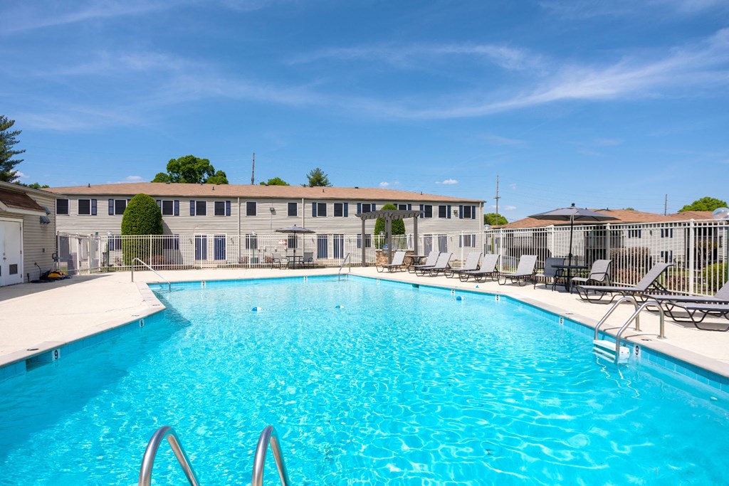 a large swimming pool with a building in the background