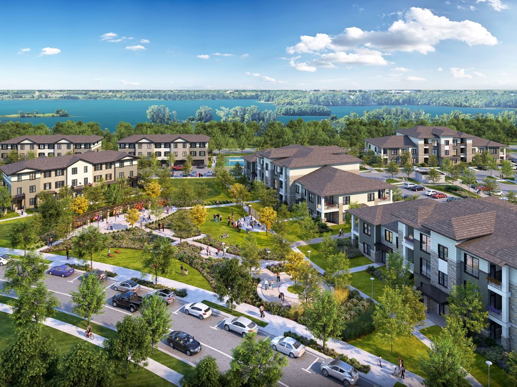 A large apartment complex with a parking lot in front.