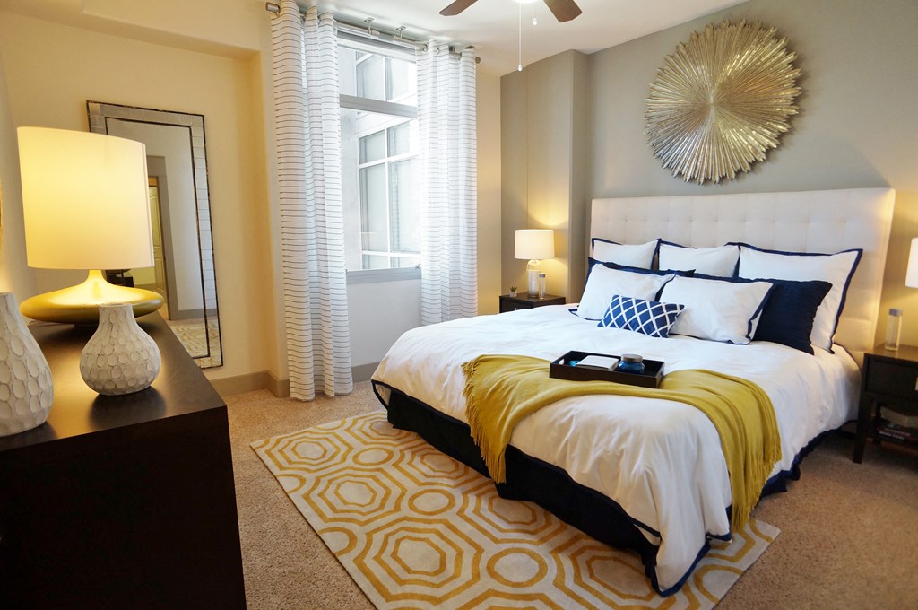 a bedroom with a white bed and yellow blanket