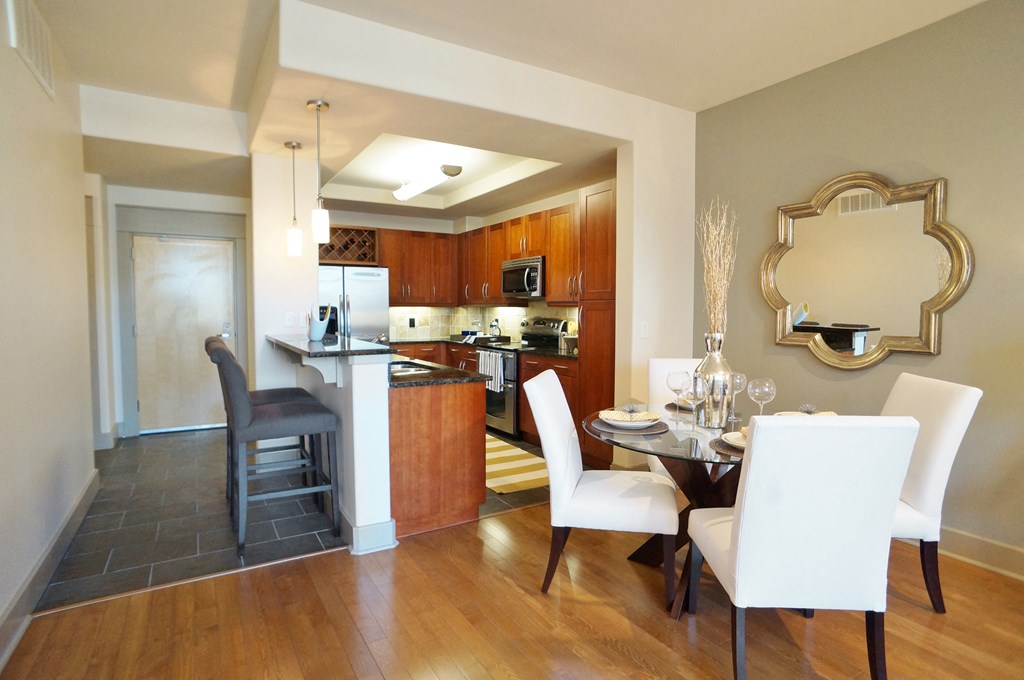 a dining room and kitchen with a table and chairs