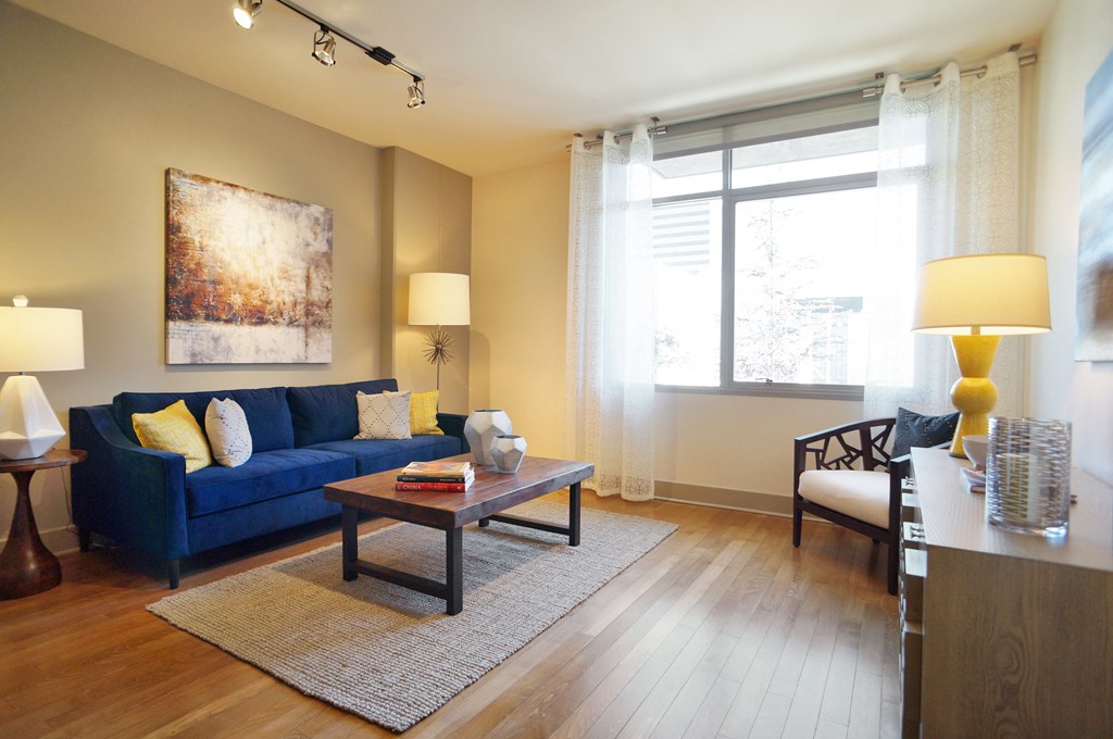a living room with a blue couch and a coffee table
