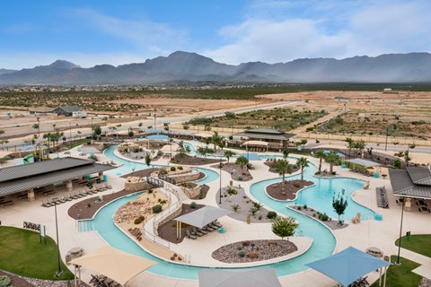 A large outdoor water park with a winding blue water slide.