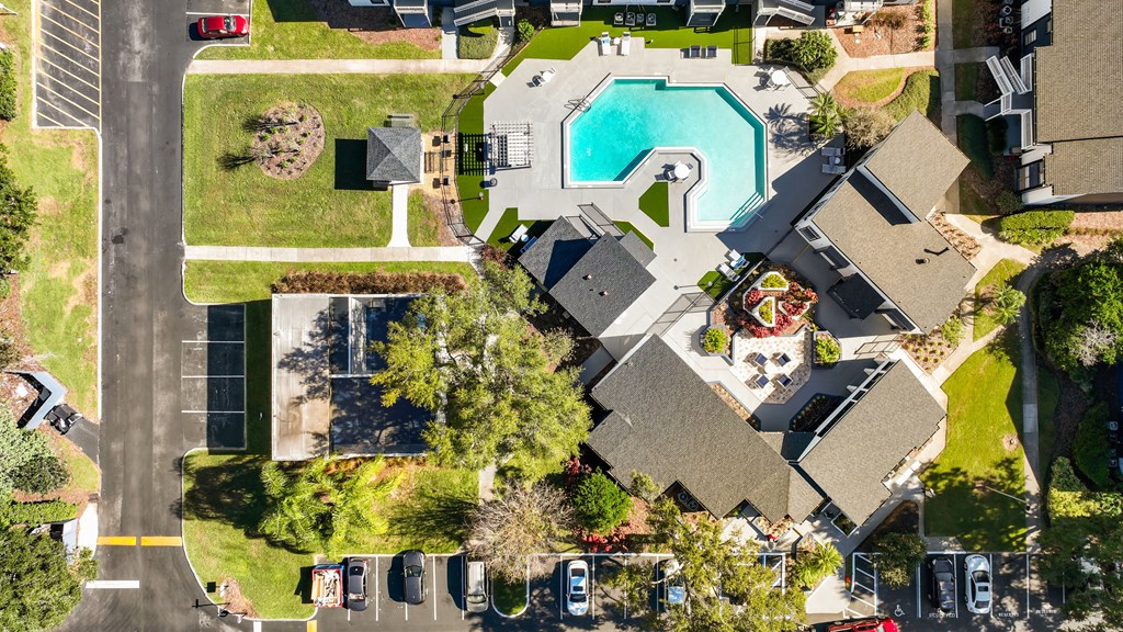 an aerial view of a house with a swimming pool in the backyard