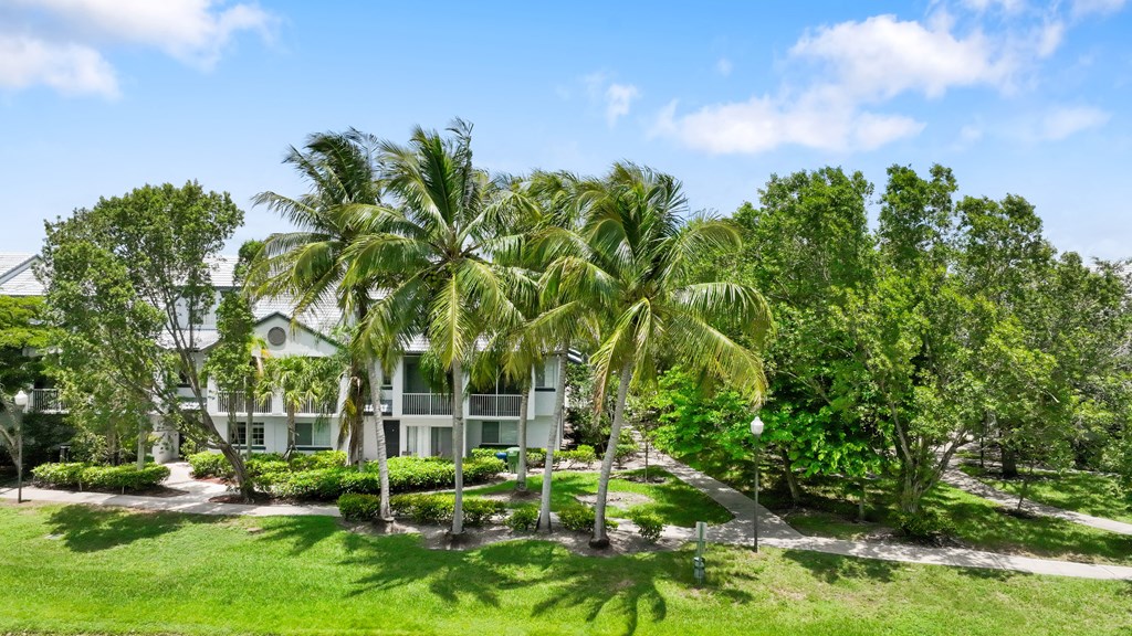 a white house with palm trees in front of it