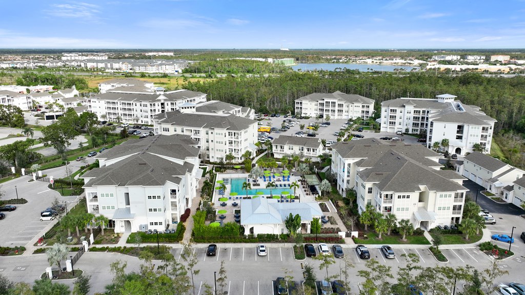 an aerial view of a large group of houses and a swimming pool