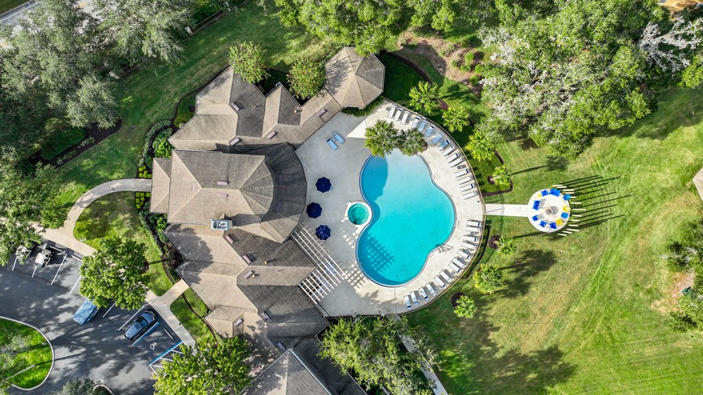 a backyard pool with a pool house and a swimming pool