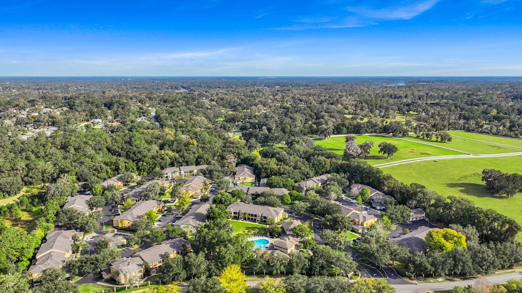 an aerial view of a neighborhood with houses and trees and a golf course