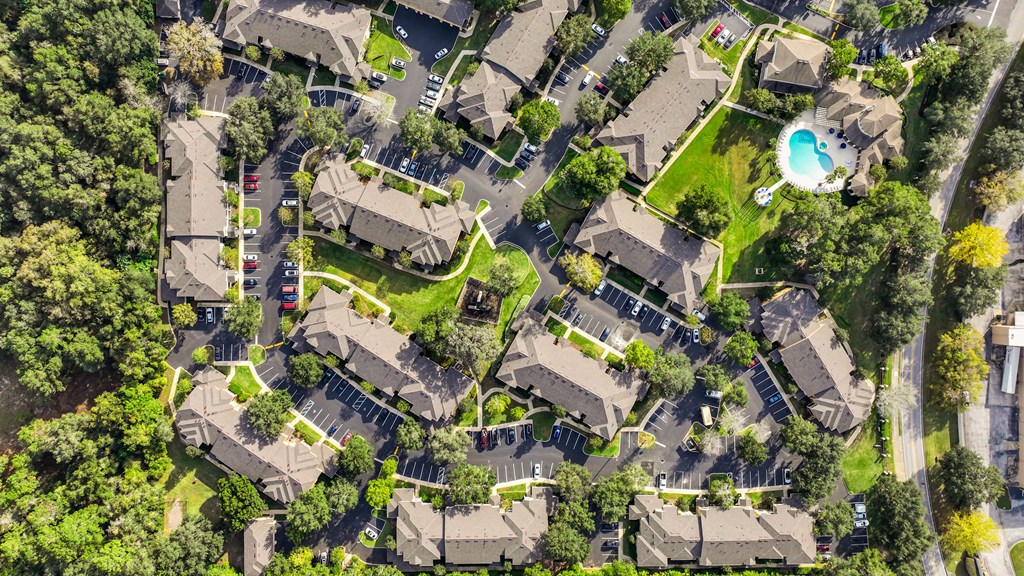 an aerial view of a neighborhood with houses and trees