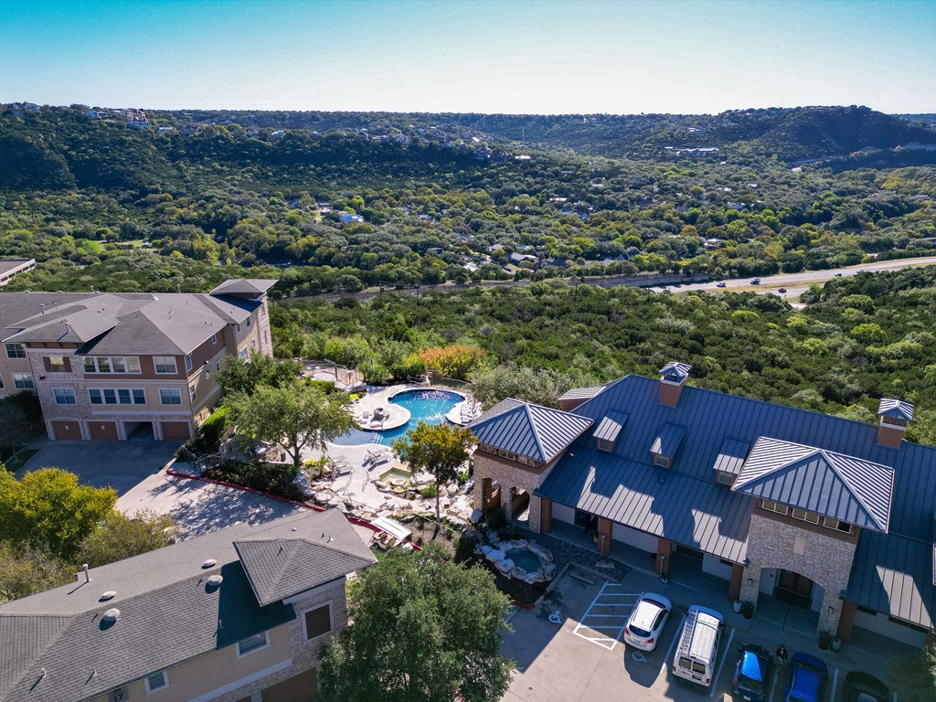 a aerial view of a resort with a swimming pool and buildings