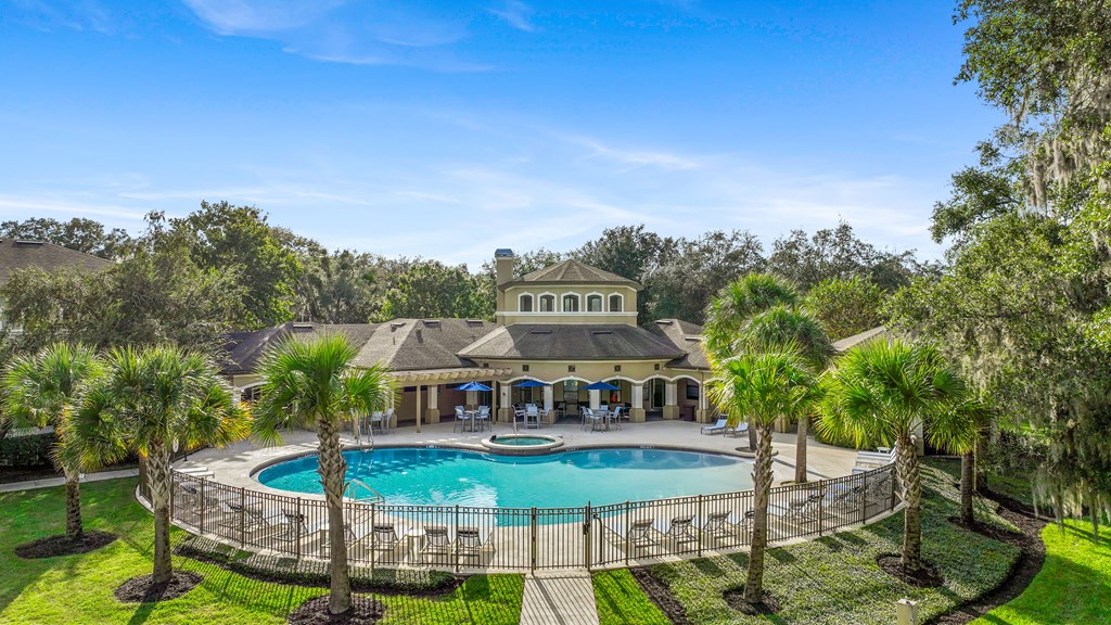 a mansion with a large pool and palm trees