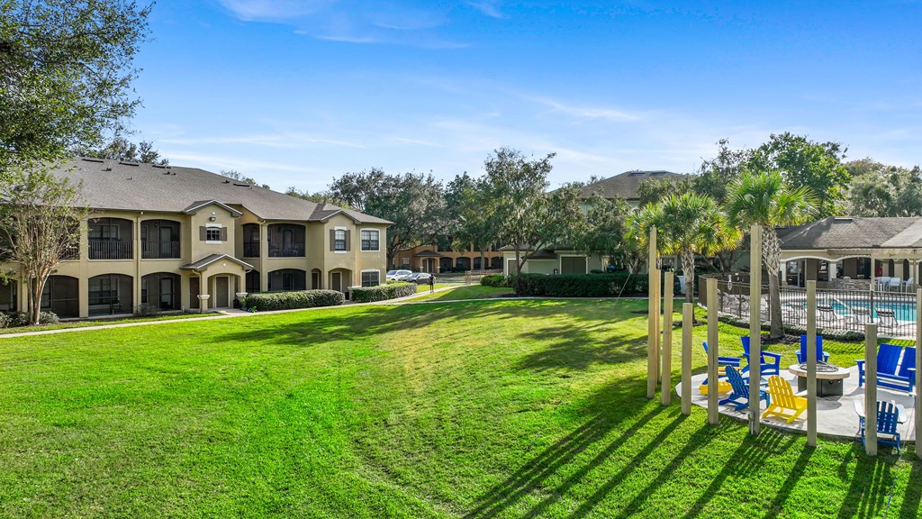 the backyard of a house with a yard and a pool