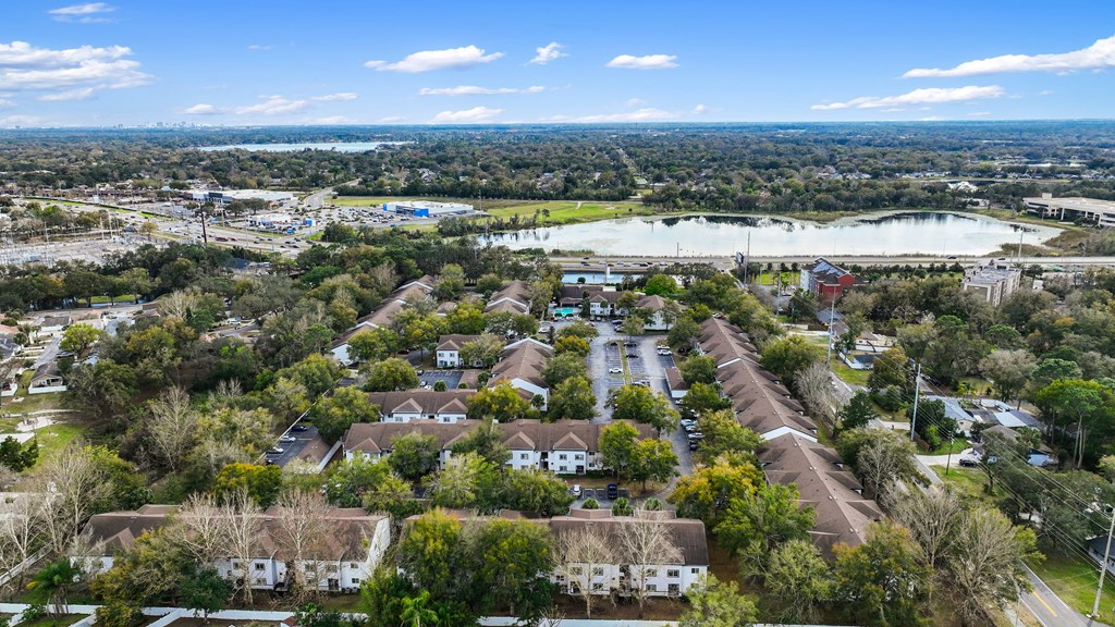 an aerial view of a neighborhood with houses and a lake