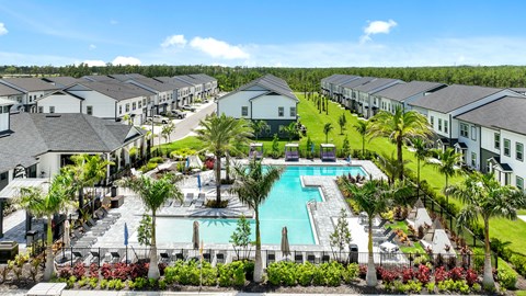 an aerial view of a swimming pool surrounded by apartment buildings