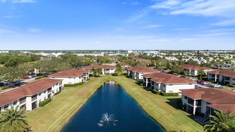 an aerial view of houses around a pool