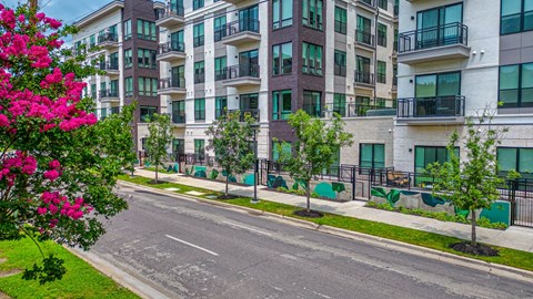a view of an empty street in front of an apartment building