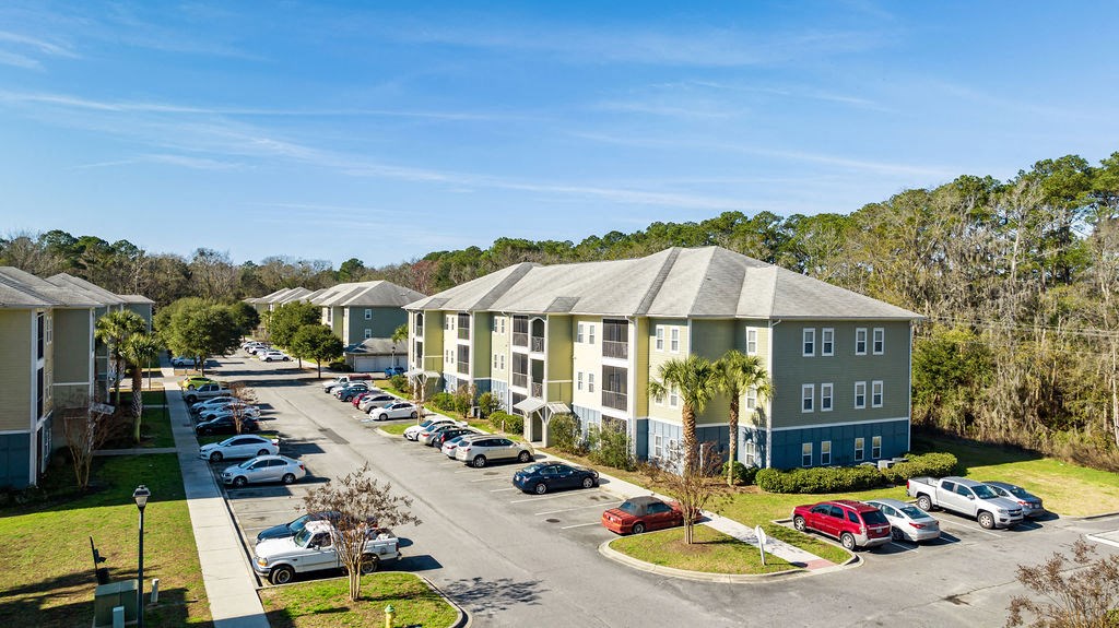 A sunny day at a residential area with cars parked in a row.