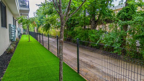 a chain link fence with a grassy area next to it