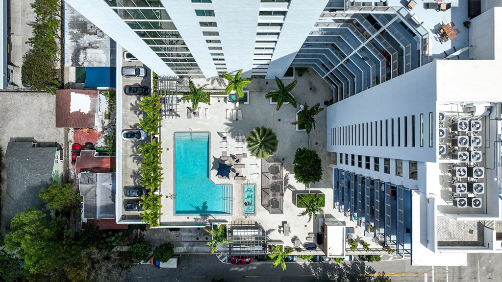 a rendering of a building with a pool and a parking lot