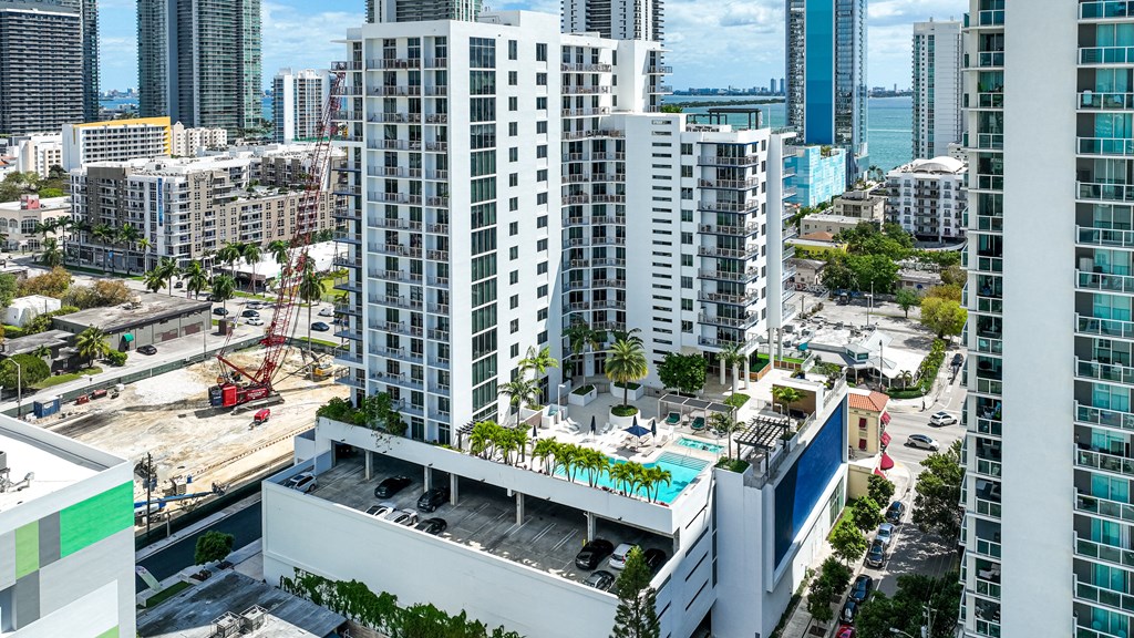 an aerial view of a city with tall buildings and a pool