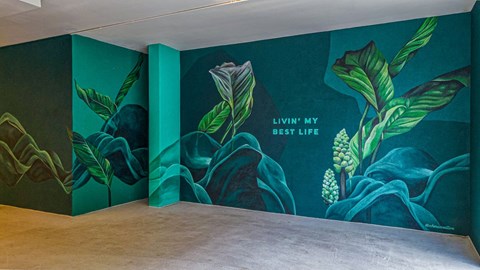 a large mural in a room with a wooden floor