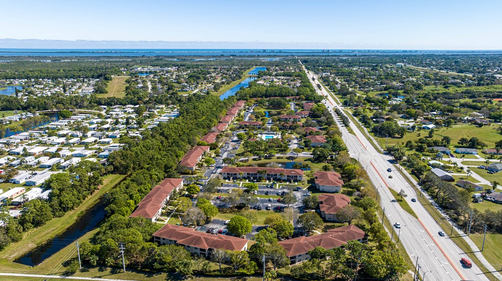 an aerial view of a neighborhood with a river in the background