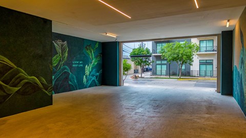 a large open space with a large mural on the wall
