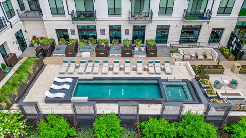 an aerial view of the pool and lounge area at the lawrenceville apartments in lawrence