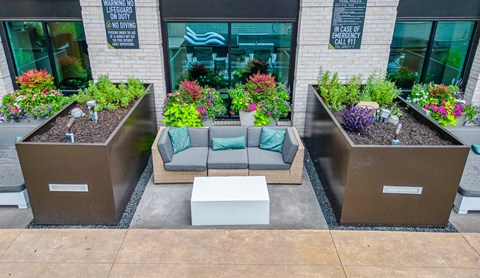 a seating area with couches and a coffee table in front of a building