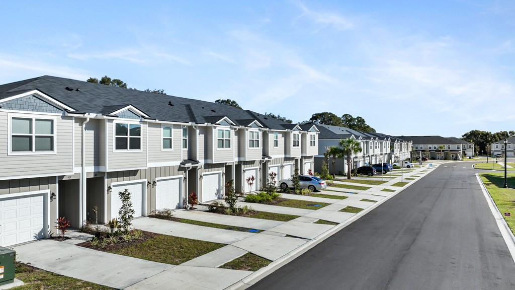 A row of houses with a clear blue sky above them.