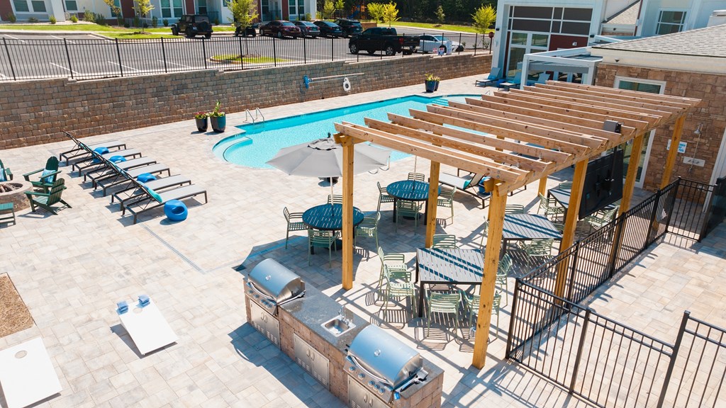 an overhead view of a resort style swimming pool with a jacuzzi
