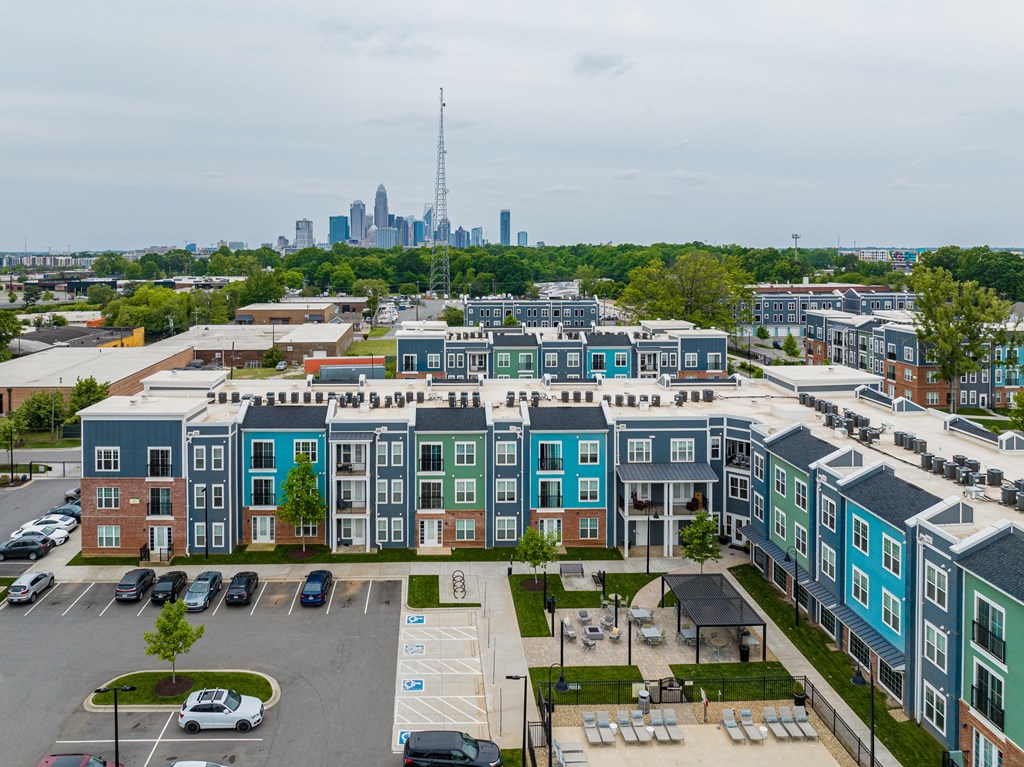 A view of a city from a high angle with apartment buildings in the foreground.